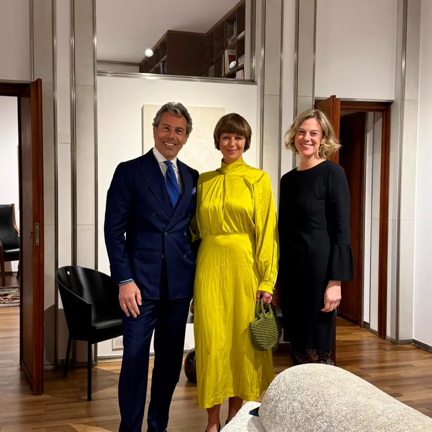 Three participants posing together at a Quintet Group event held in Milan.